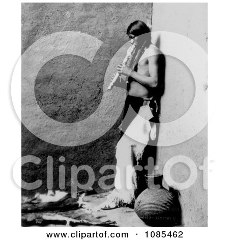 an American Indian Playing an Instrument - Free Historical Stock Photography by JVPD