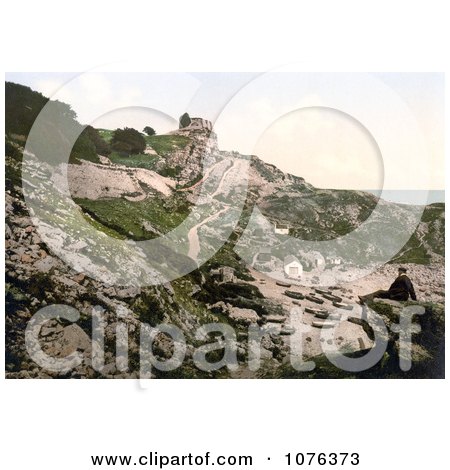 Man on a Beach Rock Looking at the Rufus Castle Ruins, Church Ope Cove, Isle of Portland, Dorset, England - Royalty Free Stock Photography  by JVPD