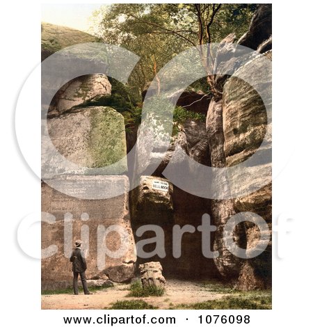 Man Reading the Carved Text on the High Rocks in Tunbridge Wells Kent England UK - Royalty Free Stock Photography  by JVPD