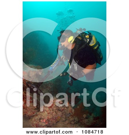 Man Using an Underwater Metal Detector - Free Stock Photography by JVPD