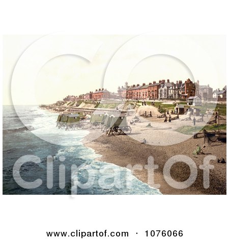 People Near Boats And Bathing Machines On The Beach In Southwell England - Royalty Free Stock Photography  by JVPD