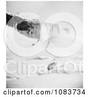 People Walking Through The Snow Towards An Icy Mountain At Niagara Falls In Winter Royalty Free Historical Stock Photography by JVPD