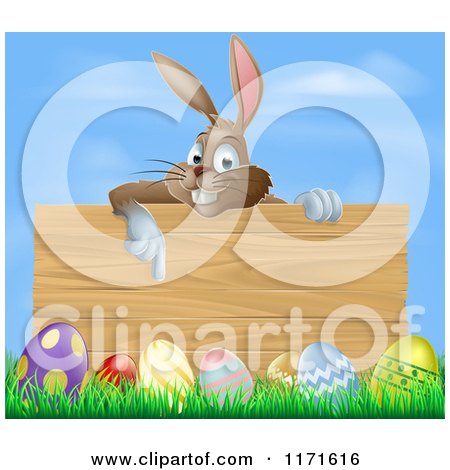 Cartoon of a Brown Easter Bunny Rabbit Pointing down at a Wood Sign over Eggs in Grass - Royalty Free Vector Clipart by AtStockIllustration