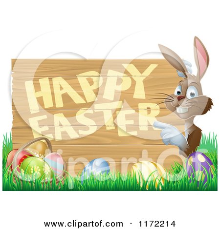 Cartoon of a Happy Bunny Pointing to a Happy Easter Sign, with a Basket and Easter Eggs in Grass - Royalty Free Vector Clipart by AtStockIllustration