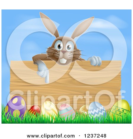 Clipart of a Brown Bunny Pointing down to a Wood Sign with Grass and Easter Eggs Against Blue Sky - Royalty Free Vector Illustration by AtStockIllustration