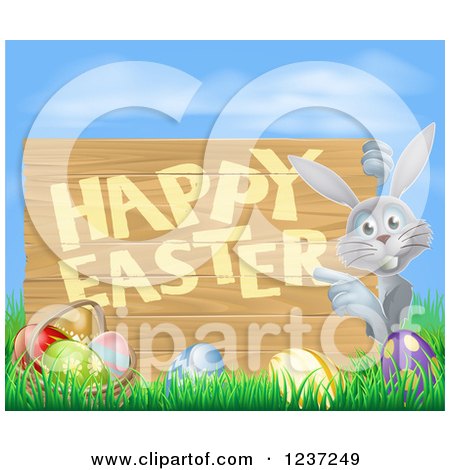 Clipart of a Gray Bunny Pointing to a Happy Easter Sign, with Easter Eggs in Grass Against Blue Sky - Royalty Free Vector Illustration by AtStockIllustration