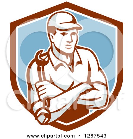 Clipart of a Retro Male Mechanic Holding a Wrench, with Folded Arms, in a Brown White and Blue Shield - Royalty Free Vector Illustration by patrimonio