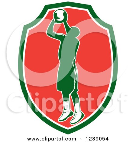 Clipart of a Retro Silhouetted Green Basketball Player Jumping and Shooting in a Green White and Red Shield - Royalty Free Vector Illustration by patrimonio