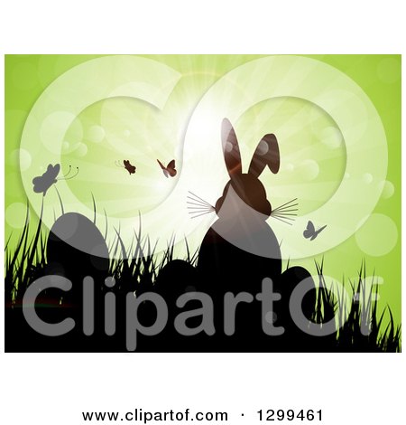 Clipart of a Silhouetted Easter Bunny with Eggs, Butterflies and Grass Against Green Magical Sunshine and Flares - Royalty Free Vector Illustration by KJ Pargeter
