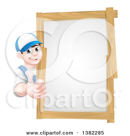 Clipart of a Happy Young Brunette Caucasian Mechanic Man in Blue, Wearing a Baseball Cap, Giving a Thumb up Around a Wood Framed Sign - Royalty Free Vector Illustration by AtStockIllustration