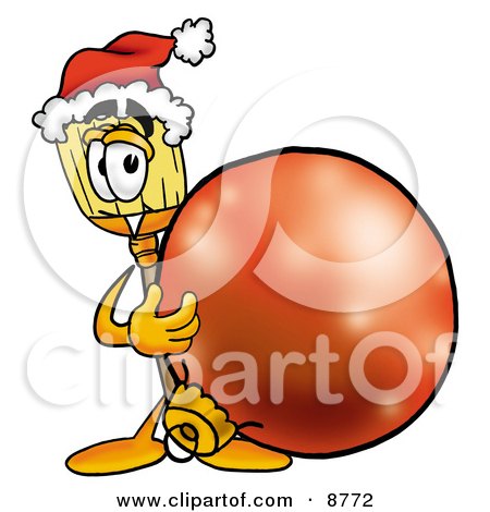 Clipart Picture of a Broom Mascot Cartoon Character Wearing a Santa Hat, Standing With a Christmas Bauble by Mascot Junction