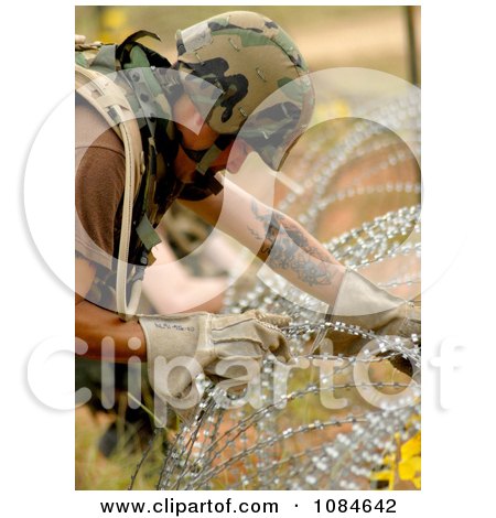 Soldier Stringing Concertina Wire - Free Stock Photography by JVPD