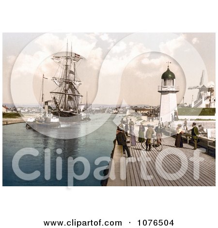 Steamboat Tugging a Ship Past the Pier and Windmill in Littlehampton Arun West Sussex England UK - Royalty Free Stock Photography  by JVPD