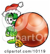 Dollar Sign Mascot Cartoon Character Wearing A Santa Hat Standing With A Christmas Bauble