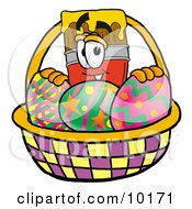 Paint Brush Mascot Cartoon Character In An Easter Basket Full Of Decorated Easter Eggs