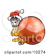 Clipart Picture Of A Pencil Mascot Cartoon Character Wearing A Santa Hat Standing With A Christmas Bauble
