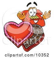 Red Telephone Mascot Cartoon Character With An Open Box Of Valentines Day Chocolate Candies