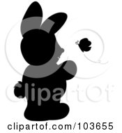 Royalty Free RF Clipart Illustration Of A Silhouetted Rabbit Standing And Watching A Butterfly by Pams Clipart