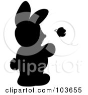 Poster, Art Print Of Silhouetted Rabbit Standing And Watching A Butterfly