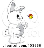 Royalty Free RF Clipart Illustration Of A White And Gray Rabbit Standing And Watching A Butterfly