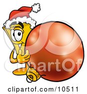 Clipart Picture Of A Yellow Admission Ticket Mascot Cartoon Character Wearing A Santa Hat Standing With A Christmas Bauble