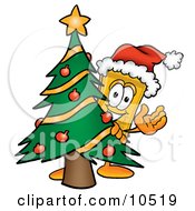 Yellow Admission Ticket Mascot Cartoon Character Waving And Standing By A Decorated Christmas Tree