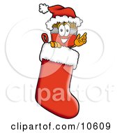 Clipart Picture Of A Paint Brush Mascot Cartoon Character Wearing A Santa Hat Inside A Red Christmas Stocking by Toons4Biz