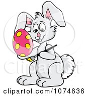 Clipart Gray Easter Bunny Decorating Eggs Royalty Free Vector Illustration