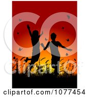 Silhouetted Children Playing In Grass And Butterflies At Sunset