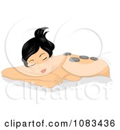 Relaxed Woman Getting A Hot Stone Massage At The Spa