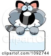 Clipart Cute Baby Raccoon Holding A Sign Royalty Free Vector Illustration
