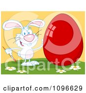 Clipart White Easter Bunny Painting A Shiny Red Egg On A Hill Royalty Free Vector Illustration