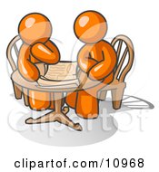 Two Businessmen Sitting At A Table Discussing Papers