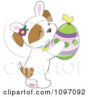 Poster, Art Print Of Cute Puppy Wearing Bunny Ears And Holding An Easter Egg With A Chick