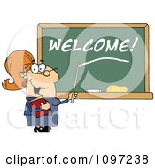 Friendly Female Teacher Pointing To Welcome On A Chalk Board