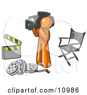 Orange Man Filming A Movie Scene With A Video Camera In A Studio