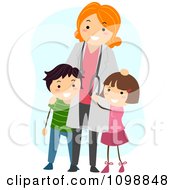 Friendly Female Pediatric Doctor Standing With Two Kids