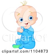Happy Baby Boy Clapping His Hands And Sitting In Blue Sleeper Pajamas