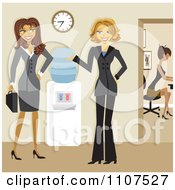 Friendly Businesswomen Talking By A Water Cooler In An Office