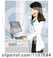 Happy Brunette Pharmacist Using A Computer