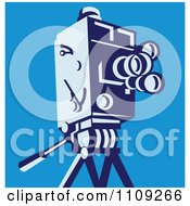 Retro Movie Video Camera On A Tripod Over Blue