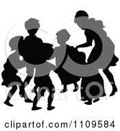Silhouetted Children Playing Ring Around The Rosie