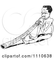 Black And White Aussie Aboriginal Man Sitting And Playing A Didgeridoo
