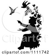 Clipart Silhouetted Man Reaching For Doves In Black And White Royalty Free Vector Illustration