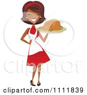 Happy Black Retro Woman Carrying A Roasted Thanksgiving Or Christmas Turkey On A Platter