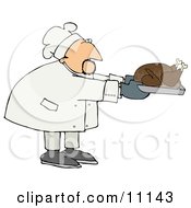 Male Chef In A Chefs Hat Holdinga Thanksgiving Turkey In A Roasting Pan Clipart Picture