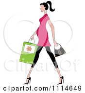 Slender Dark Haired Pregnant Woman Walking With A Shopping Bag And Purse