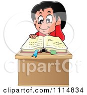 Happy Hispanic Girl Reading A Book At Her Desk
