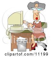 Gray Haired Secretary Woman Working At A Computer Desk In An Office