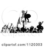 Silhouetted Girl On A Lamp Post As People Celebrate In The Street